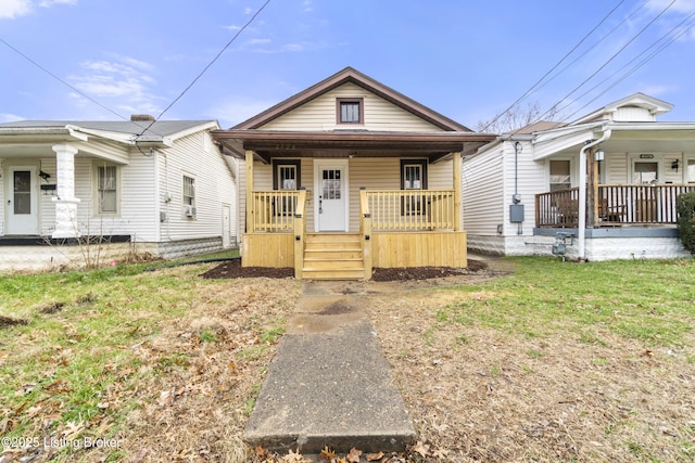 bungalow-style house with covered porch and a front lawn