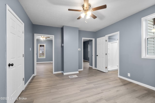 unfurnished bedroom with ceiling fan, light hardwood / wood-style floors, and a textured ceiling