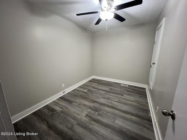 spare room featuring ceiling fan, a textured ceiling, and dark wood-type flooring