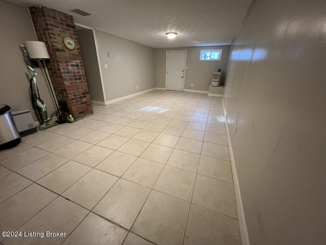 interior space featuring light tile patterned floors and a textured ceiling