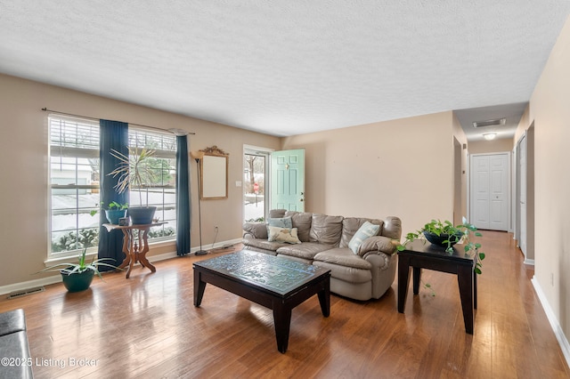 living room with hardwood / wood-style flooring and a textured ceiling