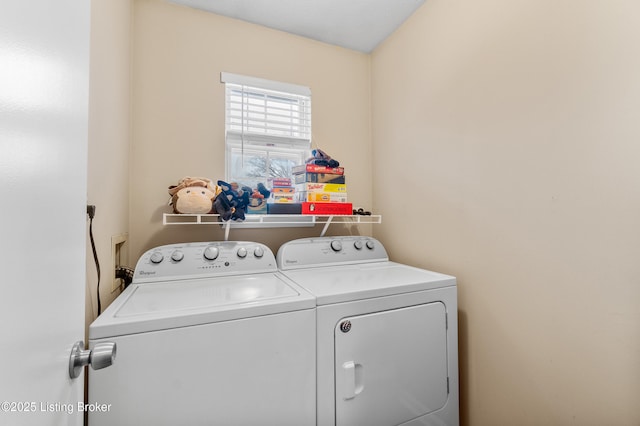 clothes washing area with separate washer and dryer