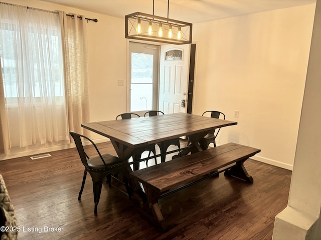 dining room with dark hardwood / wood-style flooring