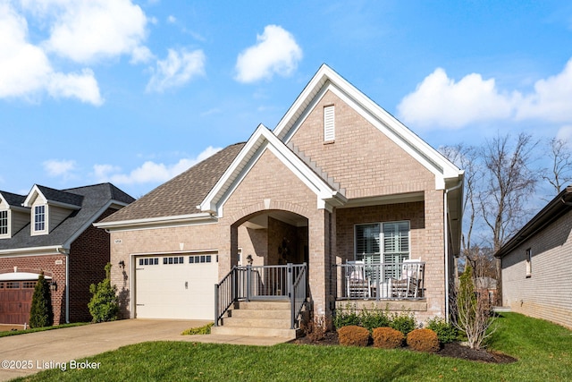 view of front of house featuring covered porch, a front yard, and a garage