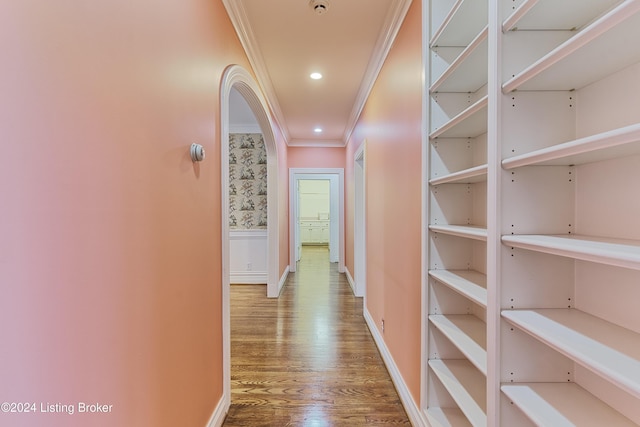 corridor with hardwood / wood-style floors and crown molding