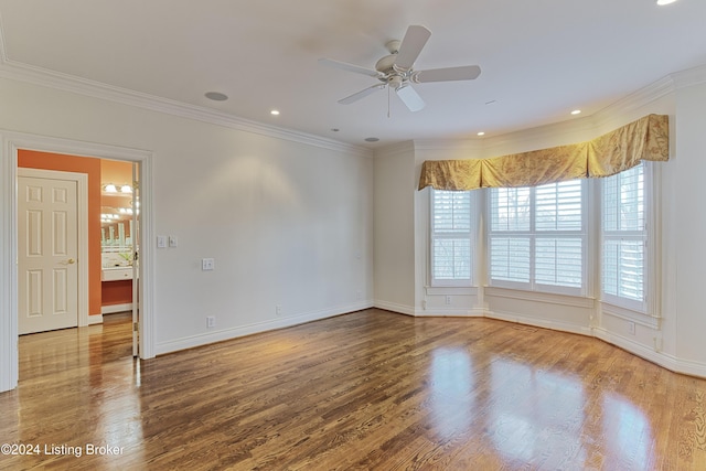 spare room with wood-type flooring, ceiling fan, and crown molding