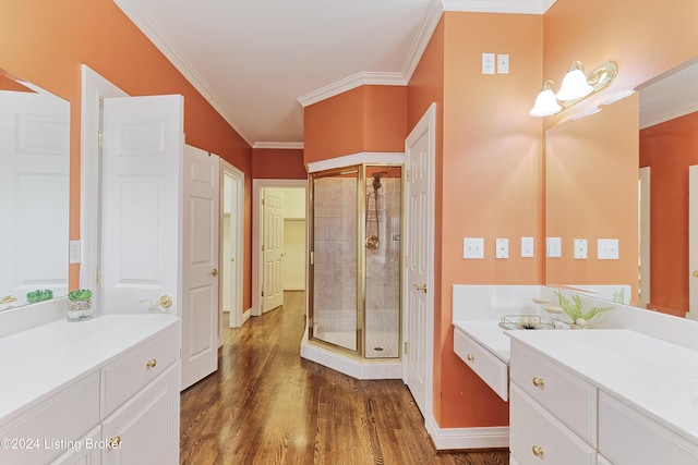 bathroom with an enclosed shower, ornamental molding, vanity, and hardwood / wood-style floors