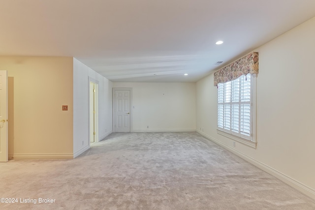 unfurnished room with light carpet