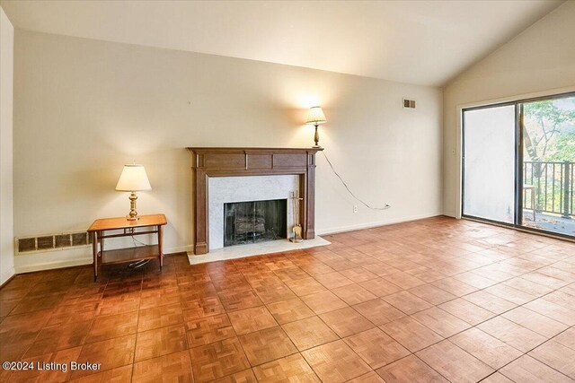 unfurnished living room featuring a fireplace and vaulted ceiling