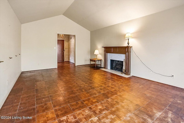 unfurnished living room with a high end fireplace and lofted ceiling