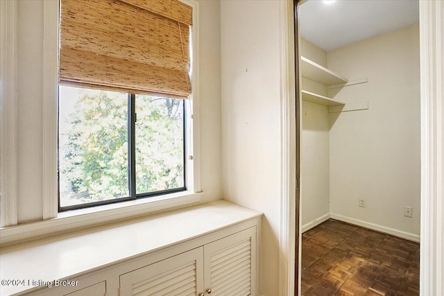 interior space with a healthy amount of sunlight and dark parquet flooring