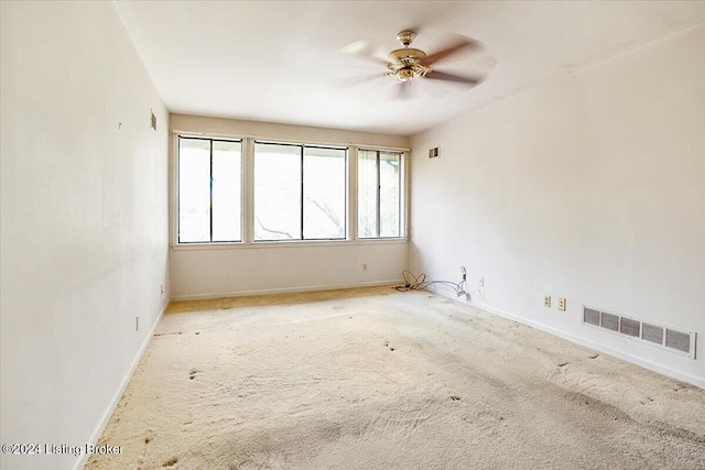 unfurnished room featuring ceiling fan and light colored carpet