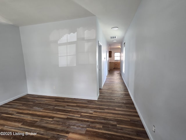 corridor with dark wood-type flooring