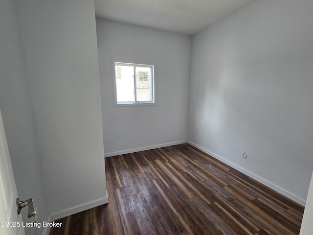 spare room with dark hardwood / wood-style floors