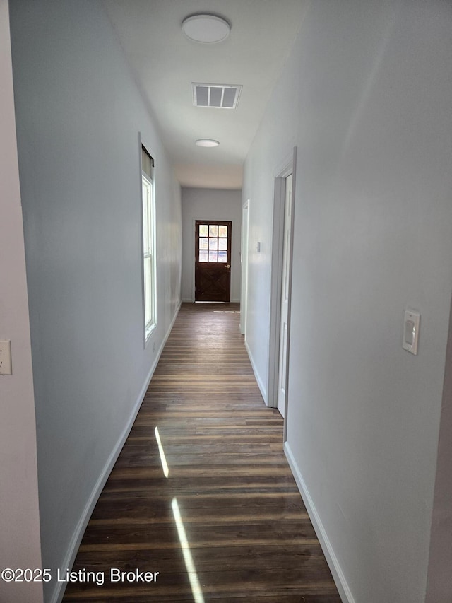 corridor with dark hardwood / wood-style floors