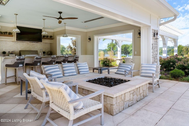 view of patio featuring ceiling fan and an outdoor living space with a fire pit