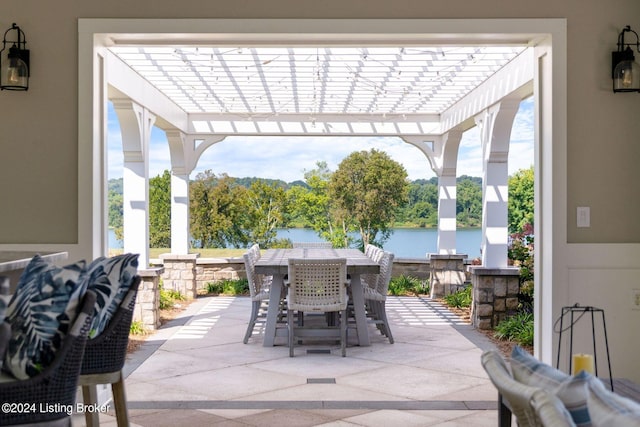 view of patio featuring a water view and a pergola