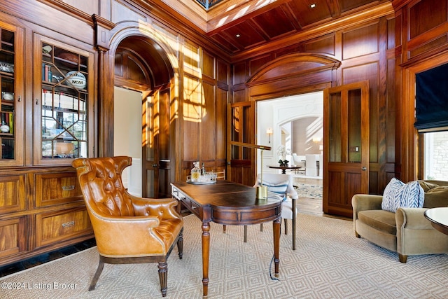 home office featuring wooden ceiling, coffered ceiling, beamed ceiling, wood walls, and ornamental molding