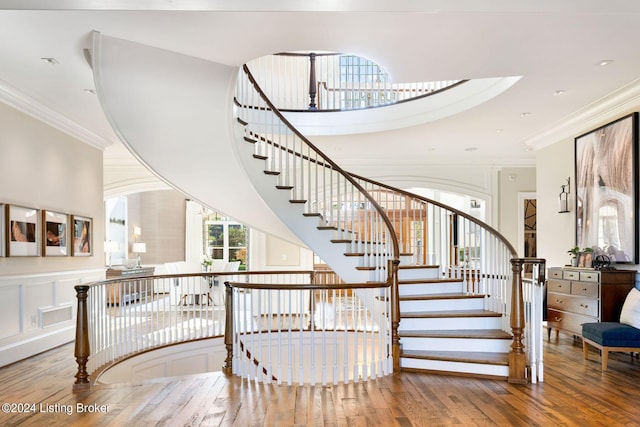 stairway featuring hardwood / wood-style flooring and crown molding