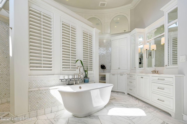 bathroom featuring ornamental molding, vanity, and independent shower and bath