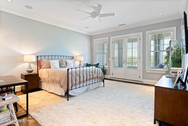 bedroom featuring ceiling fan, light wood-type flooring, and crown molding