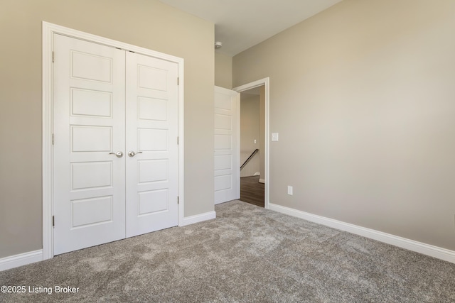 unfurnished bedroom with carpet and a closet