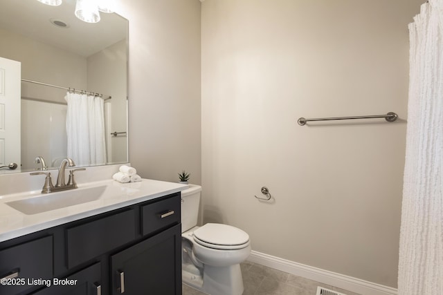 bathroom featuring tile patterned flooring, vanity, and toilet