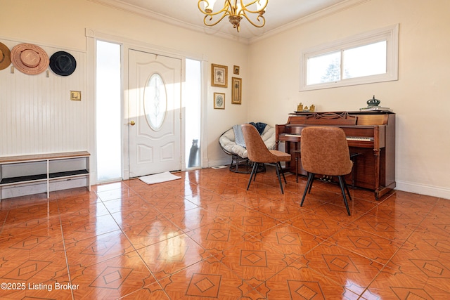 foyer with tile patterned flooring, ornamental molding, and a notable chandelier