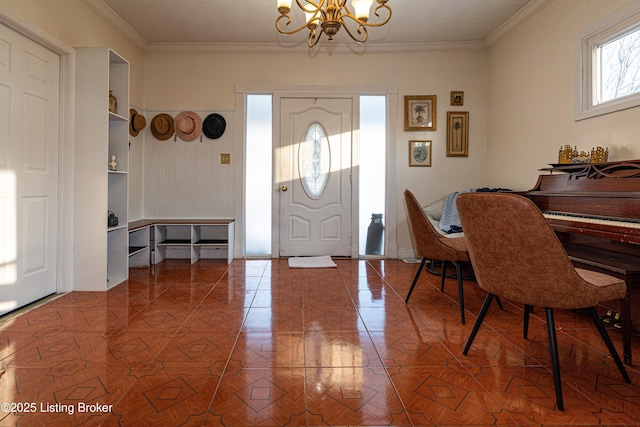 tiled foyer with a chandelier and ornamental molding