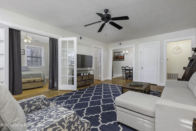 living room with wood-type flooring and ceiling fan