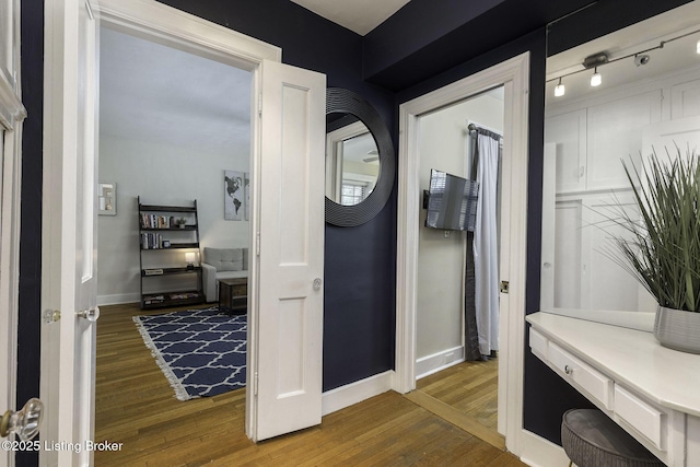 hallway with dark hardwood / wood-style floors