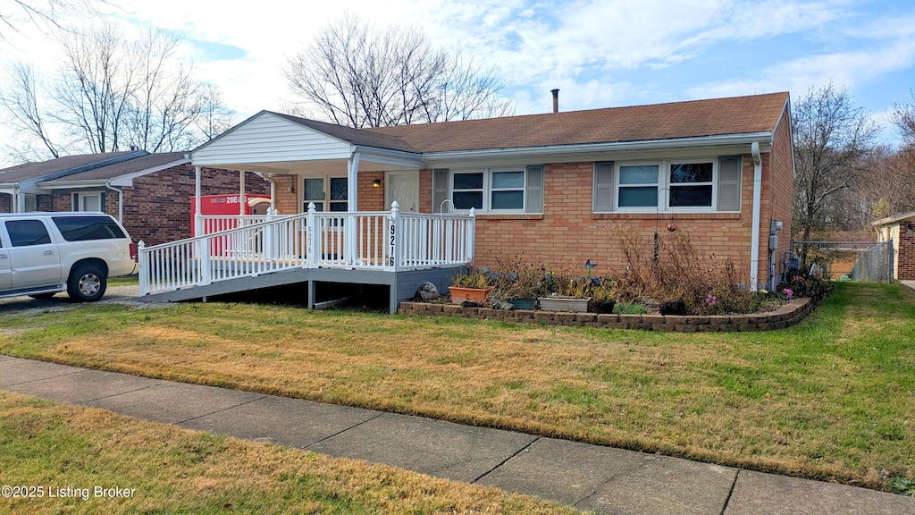 view of front facade featuring a front yard and covered porch