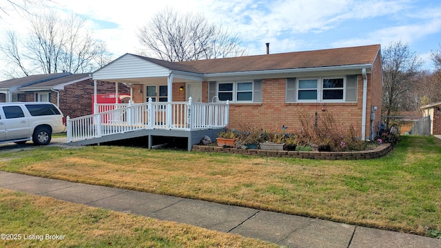 view of front facade featuring a front yard and covered porch