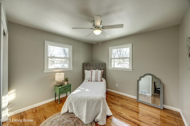 bedroom featuring ceiling fan, wood finished floors, and baseboards