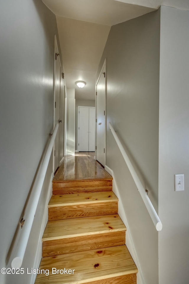 stairway with wood finished floors