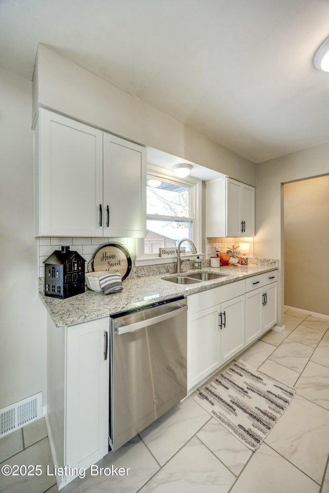 kitchen featuring visible vents, white cabinets, dishwasher, marble finish floor, and a sink