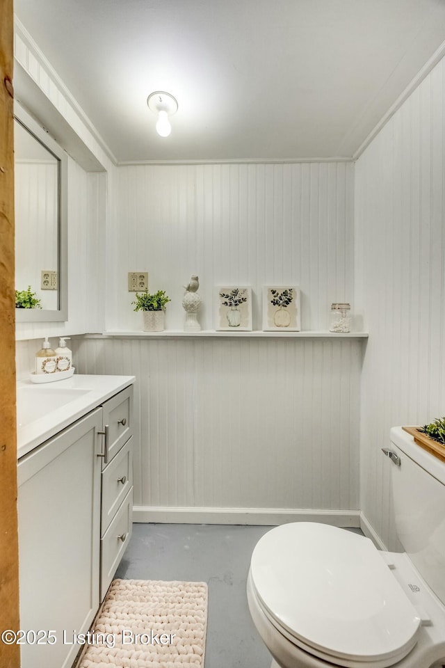 bathroom featuring concrete flooring, vanity, and toilet