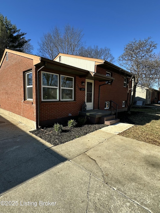 tri-level home with brick siding