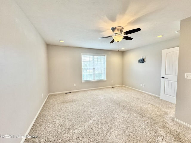 empty room with carpet flooring and ceiling fan