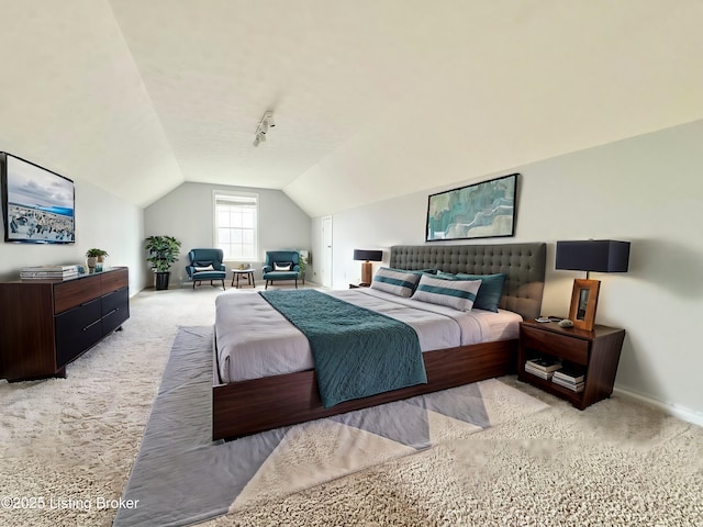 bedroom featuring light carpet and lofted ceiling