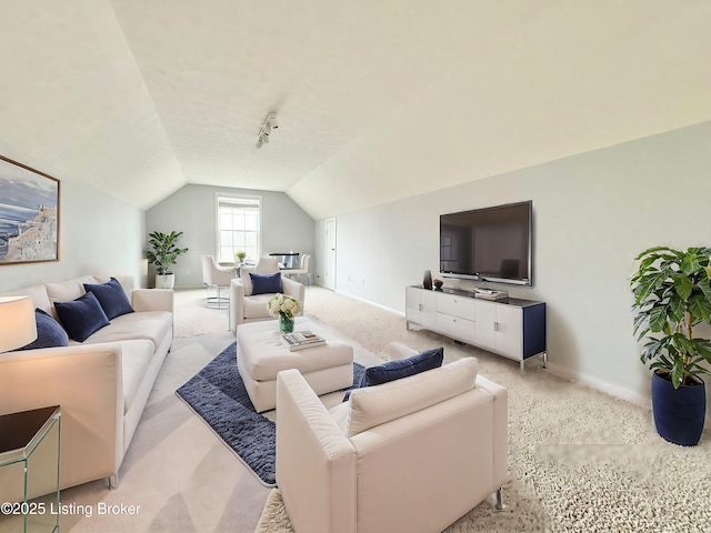 living room featuring light carpet and vaulted ceiling