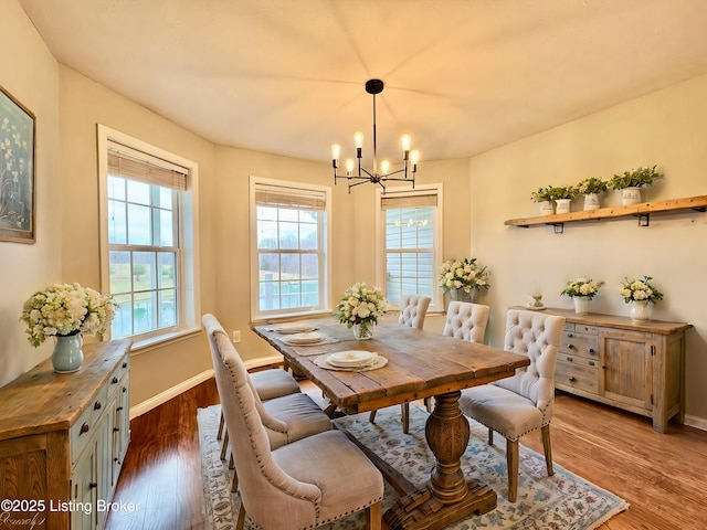 dining area with a chandelier and dark hardwood / wood-style flooring