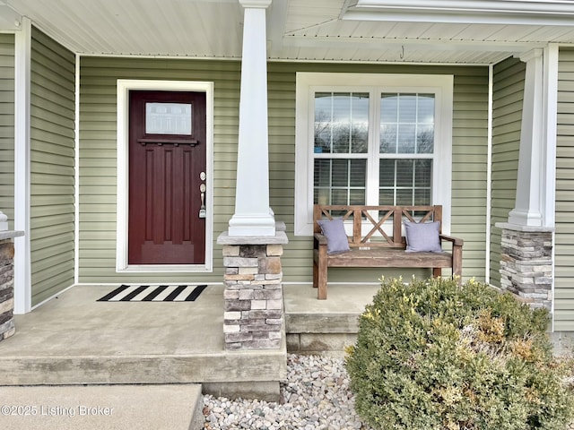 view of exterior entry with covered porch