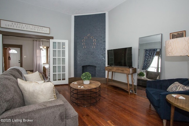 living room with a fireplace and dark hardwood / wood-style flooring