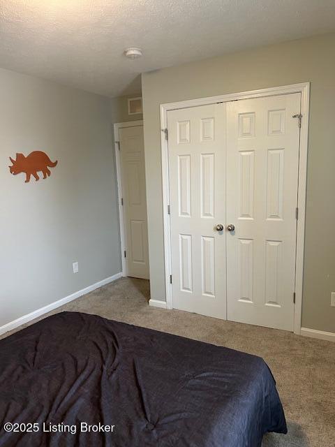 bedroom featuring carpet and a closet