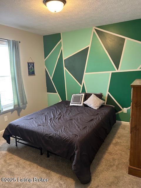 carpeted bedroom featuring a textured ceiling