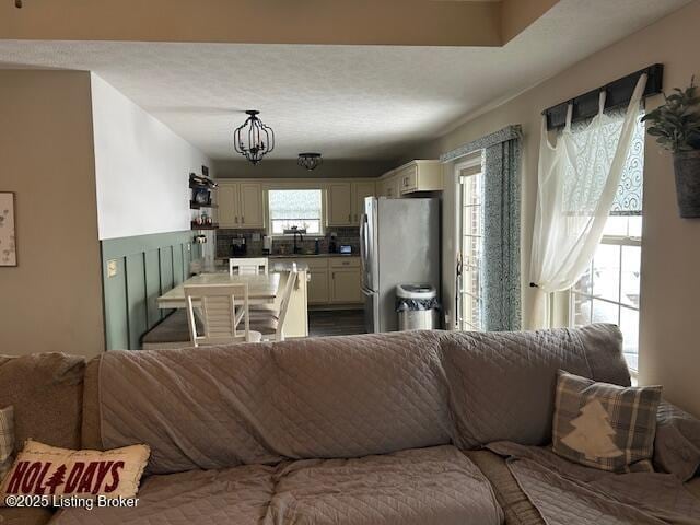 living room featuring plenty of natural light and an inviting chandelier