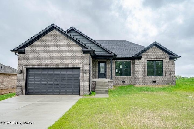 view of front of property featuring a garage and a front lawn