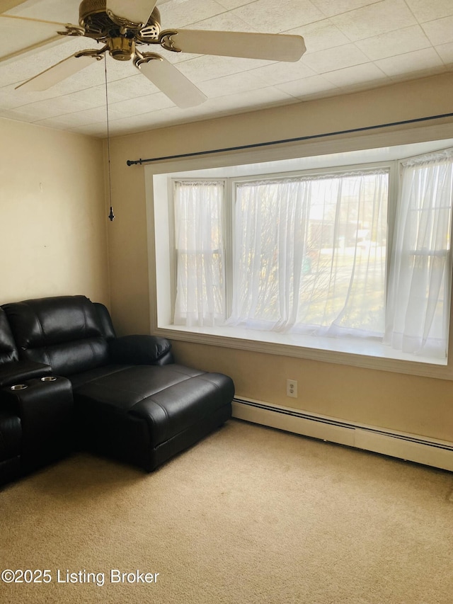 living room with carpet floors, a baseboard heating unit, a wealth of natural light, and ceiling fan