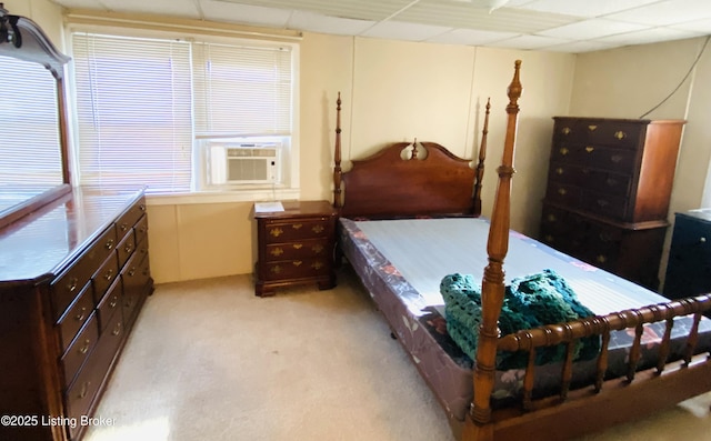 carpeted bedroom featuring cooling unit and a drop ceiling